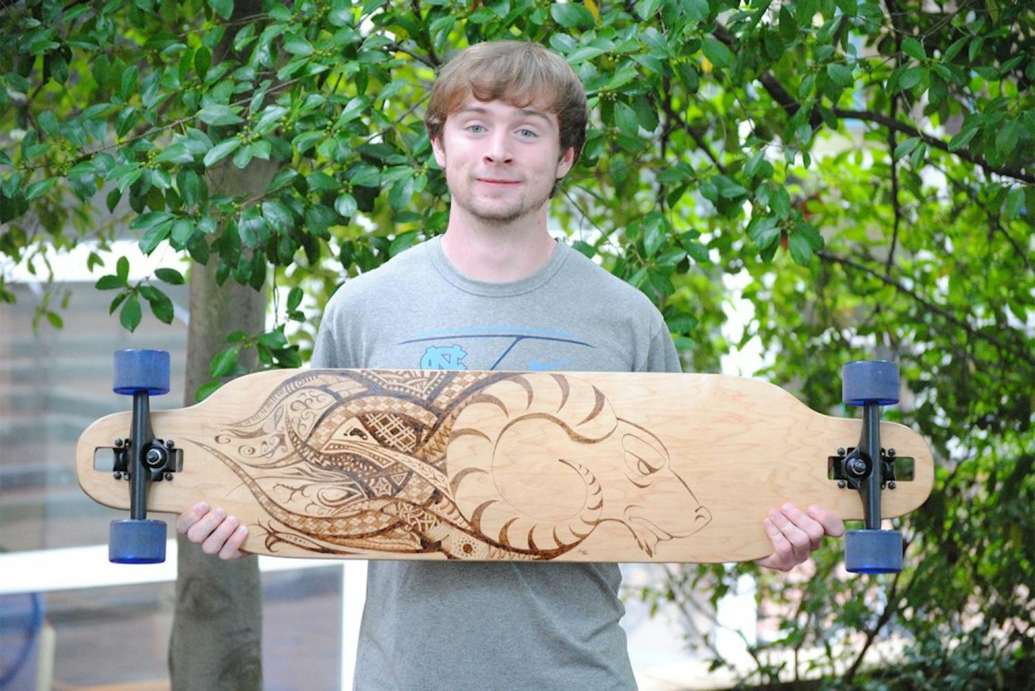 Sophomore Brandon Clark expresses his school pride and interest in art on the bottom of his longboard.