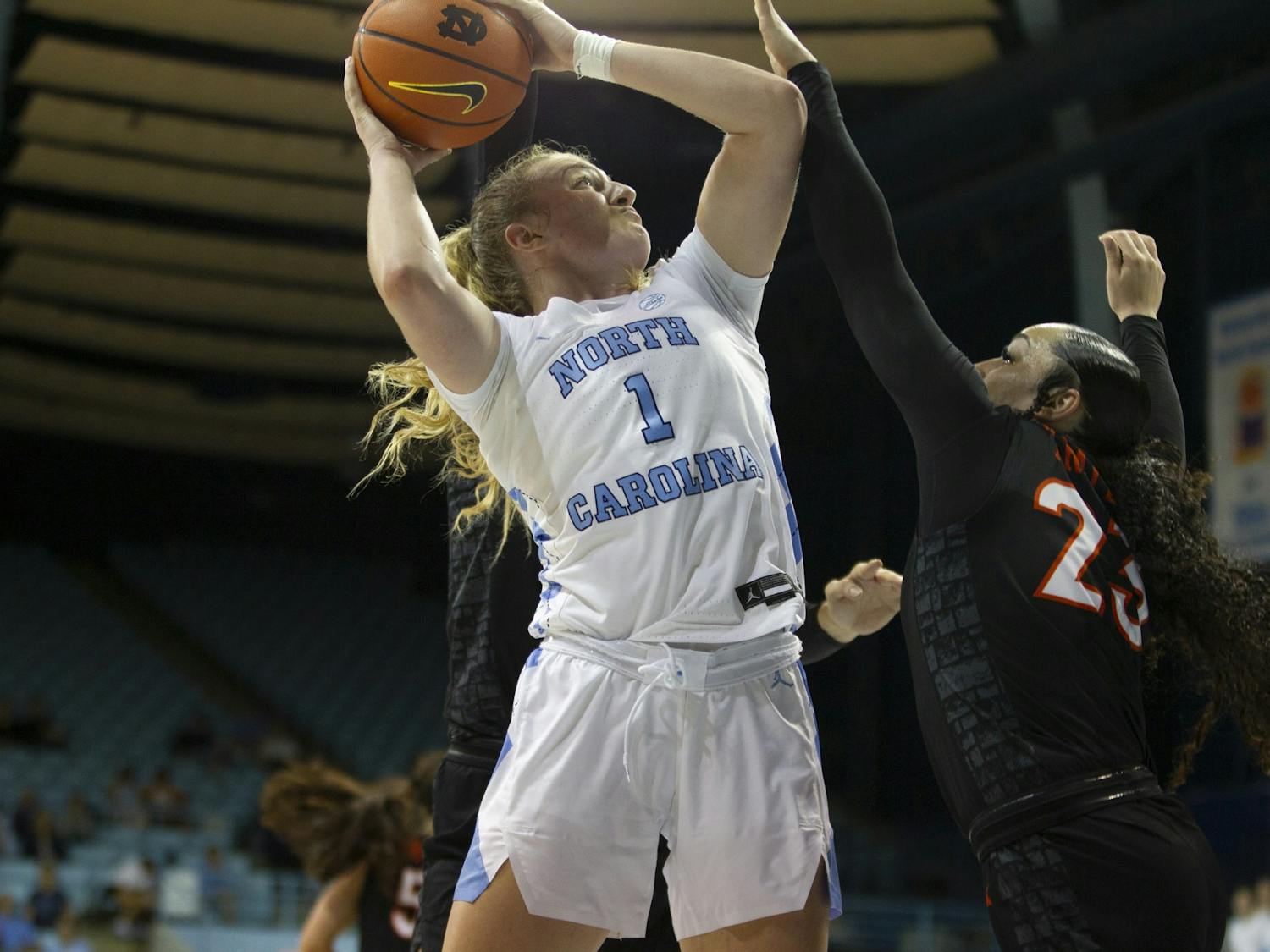 Junior forward/guard Alyssa Ustby (1) goes up for a layup during the women's basketball game against Virginia Tech on Thursday, Feb. 23, 2023, at Carmichael Arena. VT beat UNC 61-59.