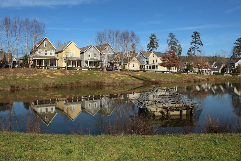 A row of houses on Hill Creek Boulevard, pictured on Tuesday, Feb. 18, 2020, sits next to a force main pipe that pumps sewage up toward the wastewater treatment plant in Chatham County. Briar Chapel residents are requesting neighborhood developers to reduce the odors and change the location of the wastewater treatment plant.
