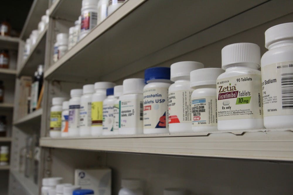 <p>Pill bottles line the back shelves of Sutton's Drug Store on Franklin Street.</p>