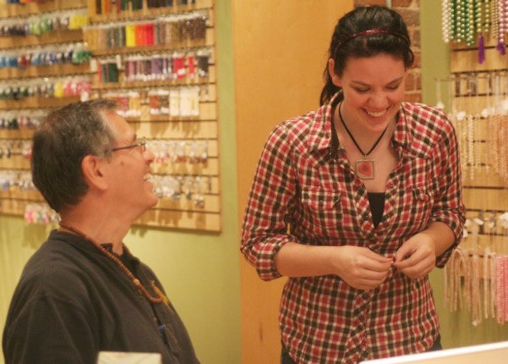 Bead Store owner David Fernandez, left, and UNC senior Evan Smith joke around in Carrboro’s Carr Mill Mall. DTH/Nicole Otto