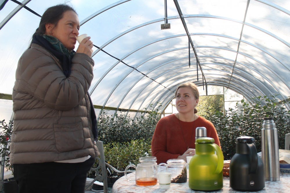 (From left to right) Local artisan Christine Parks and photographer Kathy Hampton sample some of the tea they sold at the "Meet the Makers" event held at Camellia Forest Nursery on Saturday, Nov. 17, 2018. 