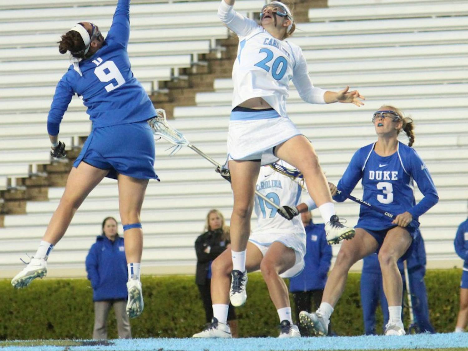 Women's lacrosse suffers a loss 7-6 to Duke in overtime on Wednesday in Kenan Stadium. Molly Hendrick (20) faces off in the first half. 