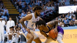 UNC junior guard RJ Davis (4) defends the basket during the men's basketball game on Sunday, Nov. 20, 2022, at the Dean Smith Center. UNC beat JMU 80-64.