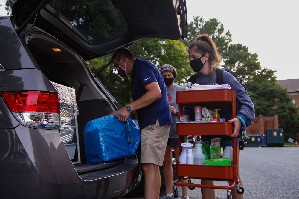 First year Miranda Darwin,  her mother Stacy and her father Ray load their car. Miranda, who previously had four in person classes before the switch to online classes was announced, moved out of Hinton James Residence Hall on Tuesday, Aug. 18, 2020.