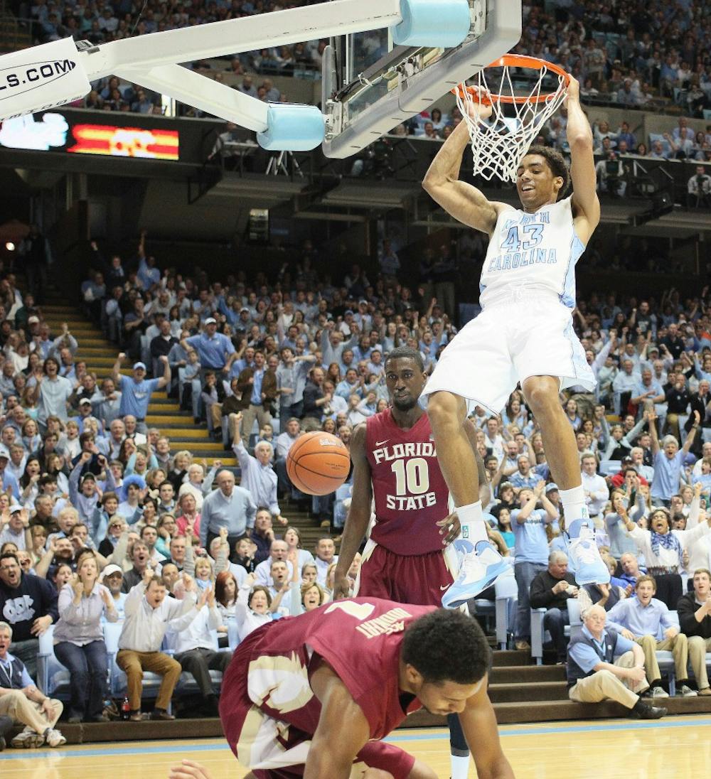 	James Michael McAdoo hangs on the rim after a put-back dunk. McAdoo scored a game high 21 points on 10-15 shooting.