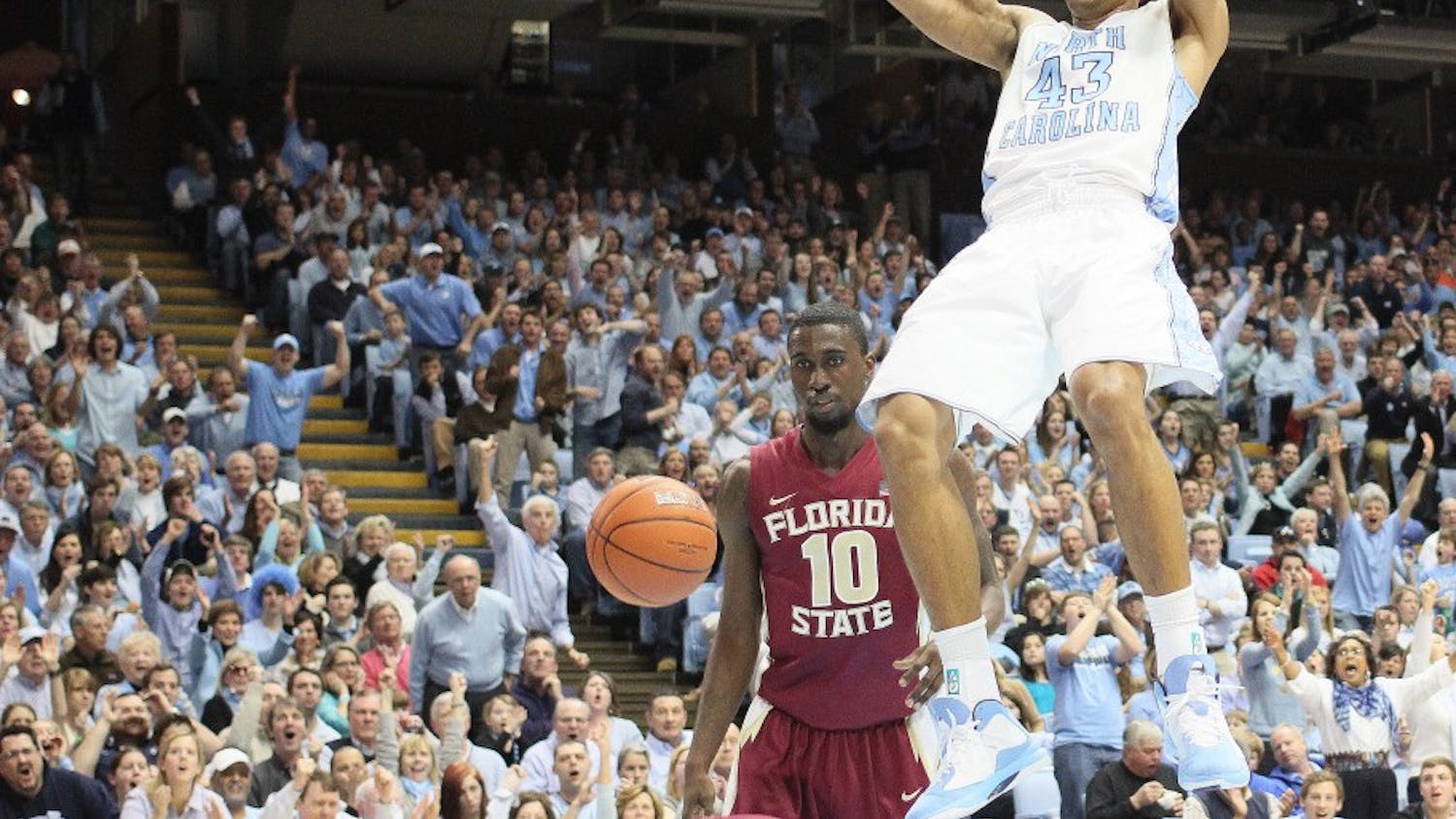	James Michael McAdoo hangs on the rim after a put-back dunk. McAdoo scored a game high 21 points on 10-15 shooting.