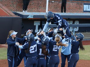 The blue scrimmage team celebrates graduate Sara Jubas (14) on her home run by throwing her into the air. UNC Softball scrimmaged at G. Anderson Stadium on Monday, Jan. 31, 2022