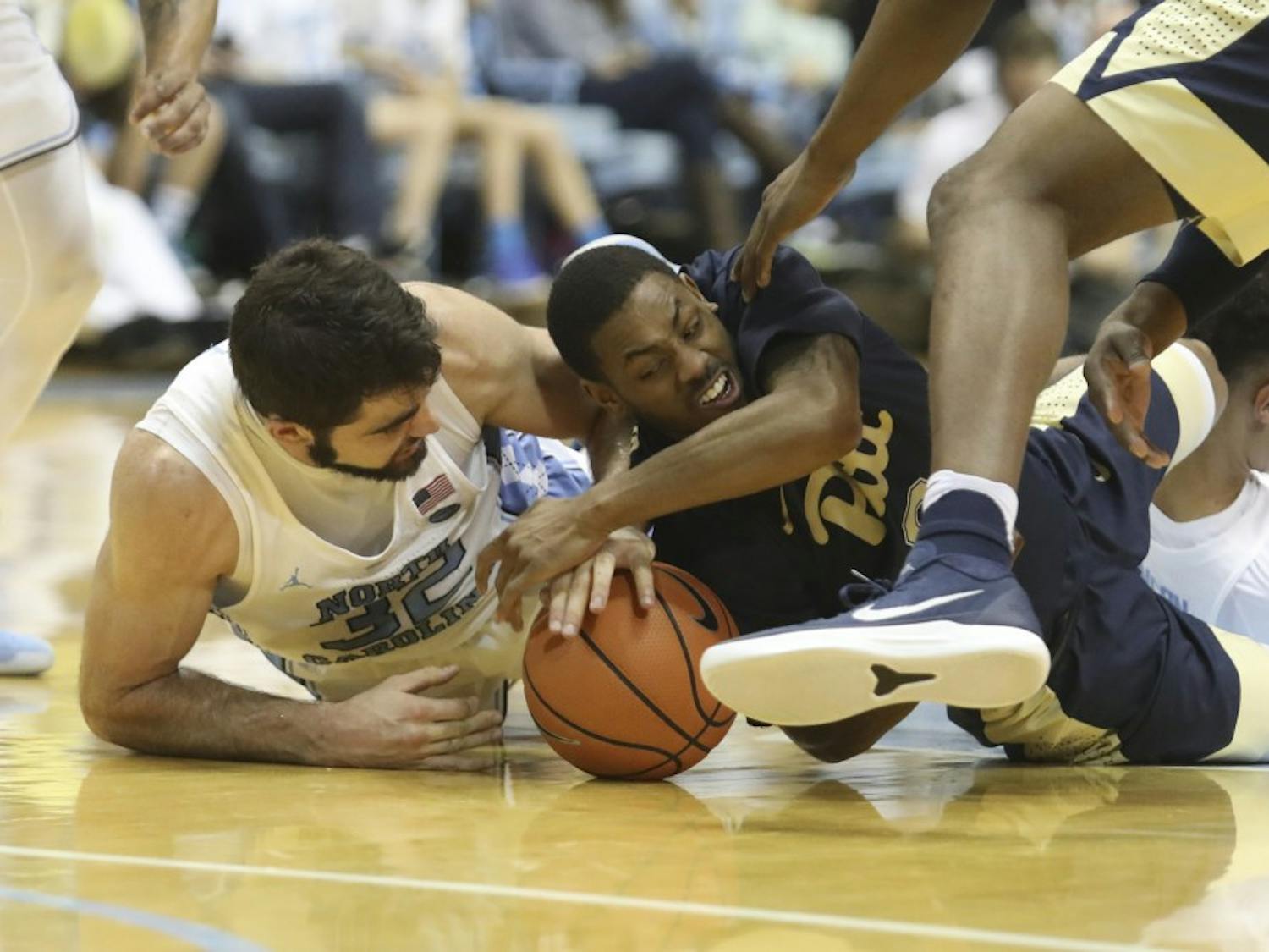 Forward Luke Maye (32) fights for possession of a loose ball against Pittsburgh on Feb. 3 in the Smith Center.