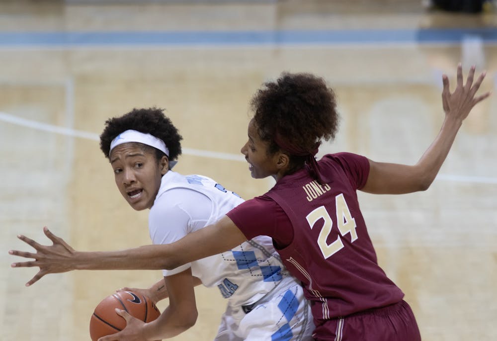 UNC freshman guard Kennedy Todd-Williams (3)  looks to pass the ball against Florida State junior guard Morgan Jones (24) on Thursday, Feb. 4, 2021. UNC fell to Florida State 61-51