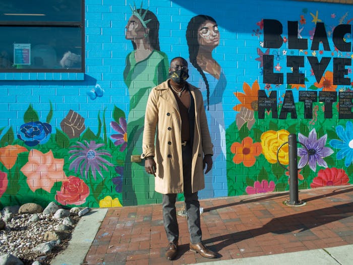 Ty Small, Coordinator of the Black Lives Matter Mural at the Community Worx building in Carrboro, stands in front of his work on Monday Jan. 11 2021.