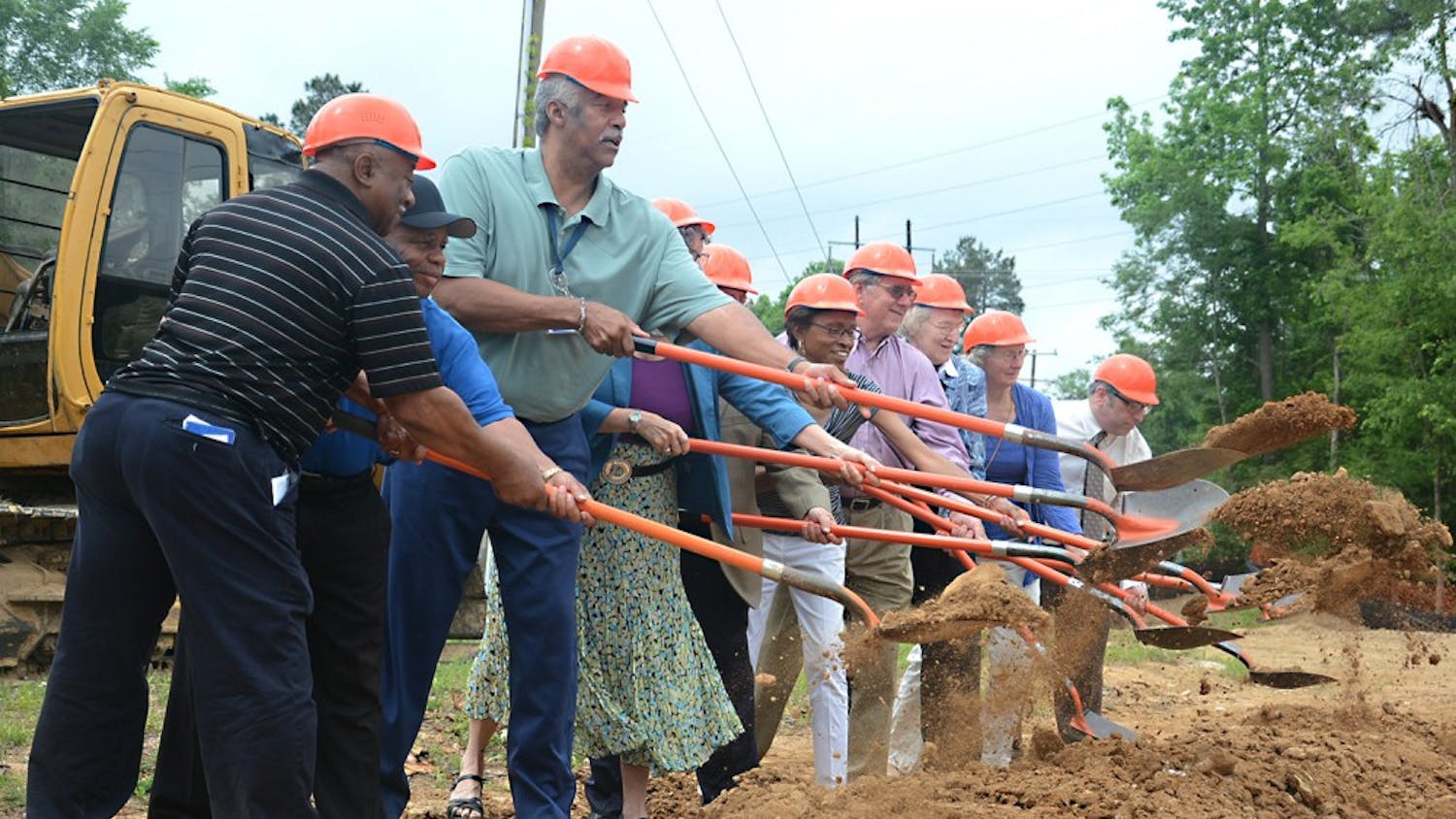 Leaders of the Orange County community break ground at the site of the new community building on Rogers Road.