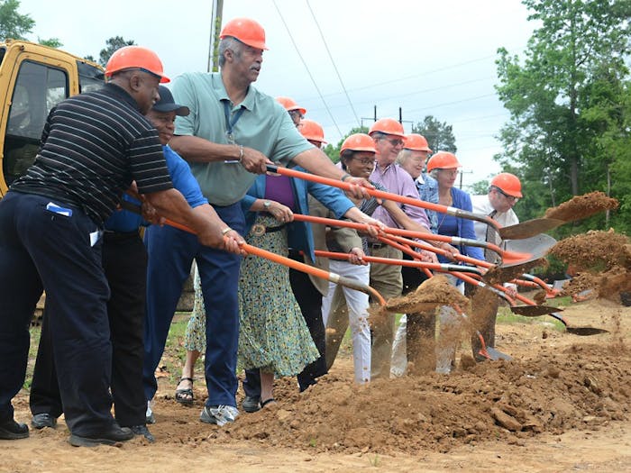 Leaders of the Orange County community break ground at the site of the new community building on Rogers Road.