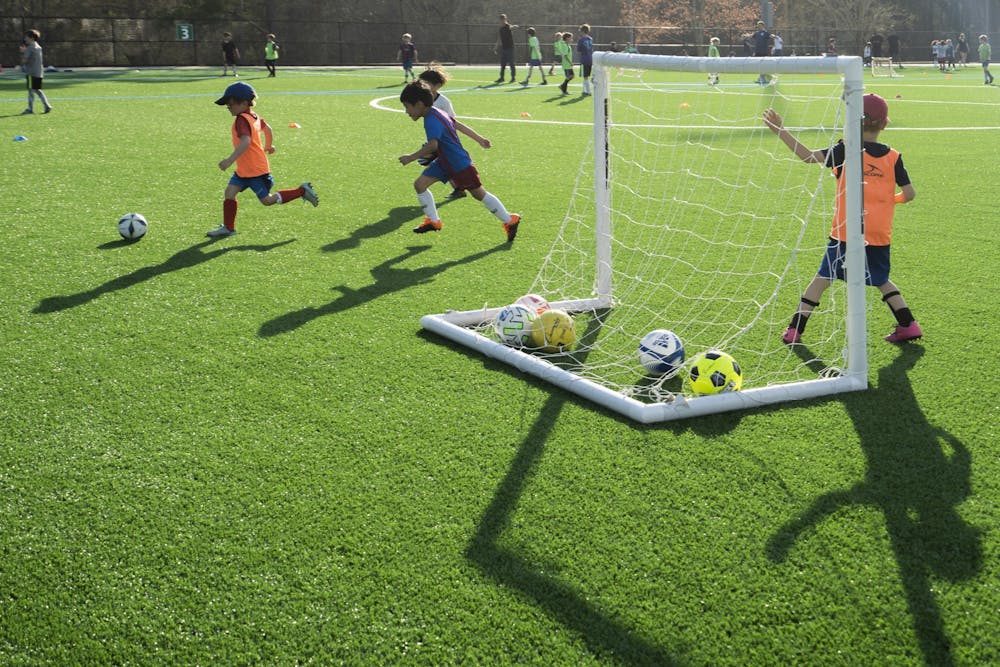 <p>Young soccer players do a drill with their team on the new turf at Cedar Falls Park in Chapel Hill, N.C., on Thursday, Mar. 23, 2023. The Town of Chapel Hill held a ribbon-cutting ceremony to celebrate the freshly redone, environmentally-friendly turf for the multi-purpose field.</p>