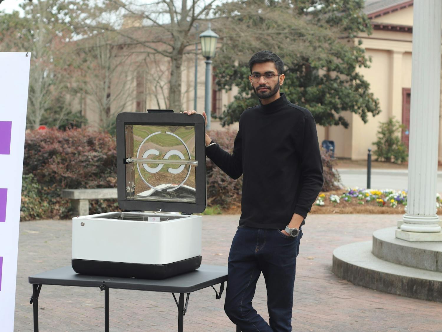 Aditya Bhatt, the Co-Founder & CEO Ultraloop Technologies, poses outside the Old Well with a sanitation device. Photo courtesy of Ultraloop Technologies. 