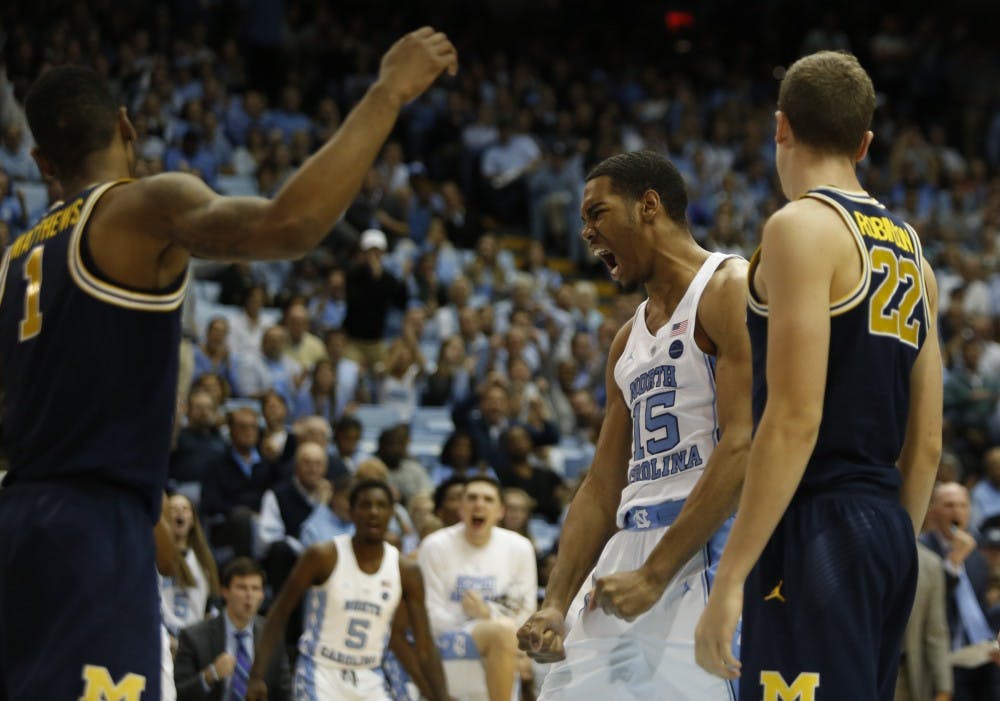 <p>Forward Garrison Brooks (15) celebrates after a play during a game against Michigan on Nov. 29 in the Smith Center.</p>
