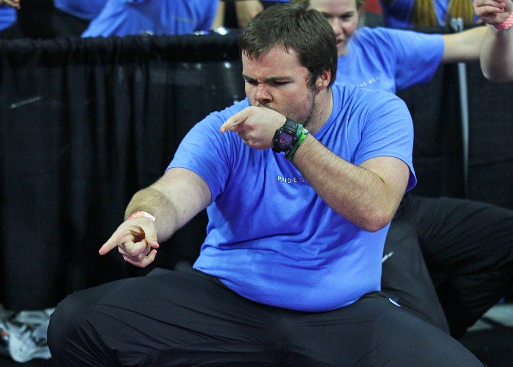 Marching Tar Heels trombone player Paul Beam dances during halftime to Flo Rida’s “Low” with fellow band members.