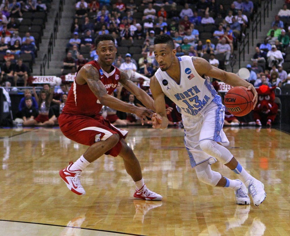 UNC forward J.P. Tokoto (13) drives toward the basket. The Tar Heels defeated the Arkansas Razorbacks, 87-78, on Saturday in Jacksonville, Fla.