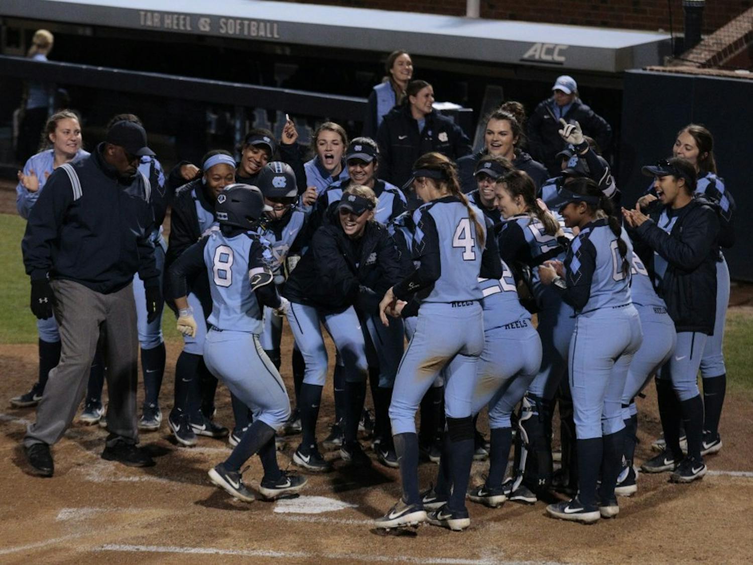 The UNC women's softball team welcomes junior outfielder Kiani Ramsey (8) to the home plate after she hit a home-run during UNC's 11-5 win over Maryland at Anderson Stadium on Sat. March 2, 2019.