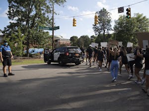 UNC athletes marched along Franklin Street to protest racial injustice on Aug. 29, 2020 in Chapel Hill, N.C. Athletes representing various UNC sports dressed in black, brought signs and called for the end of police brutality shortly after police shot Jacob Blake seven times in the back in Kenosha, Wis., on Aug. 23, 2020.