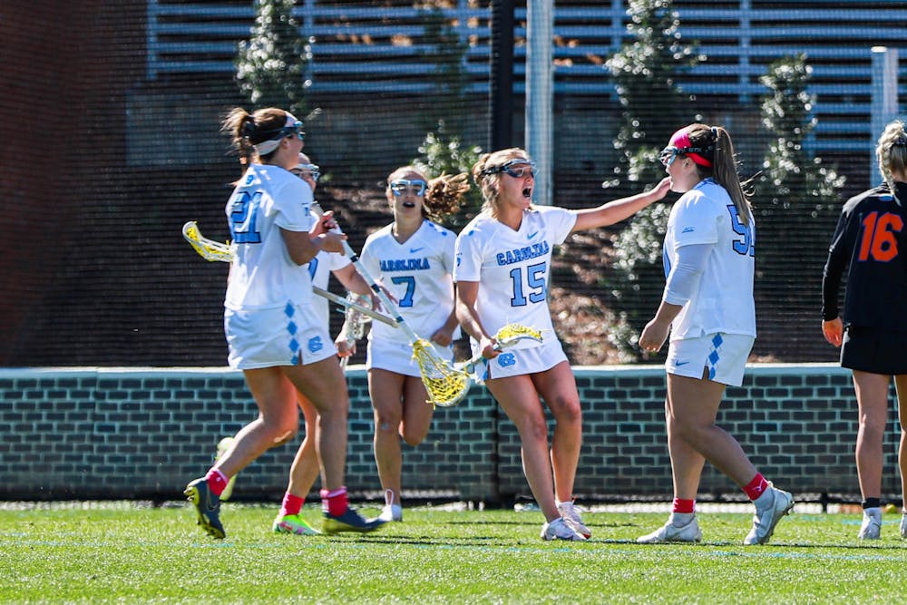 The UNC women’s lacrosse team celebrates after scoring a goal during the game against UF on Saturday, Feb. 18, 2023, at Dorrance Field. UNC beat UF 12-5.
