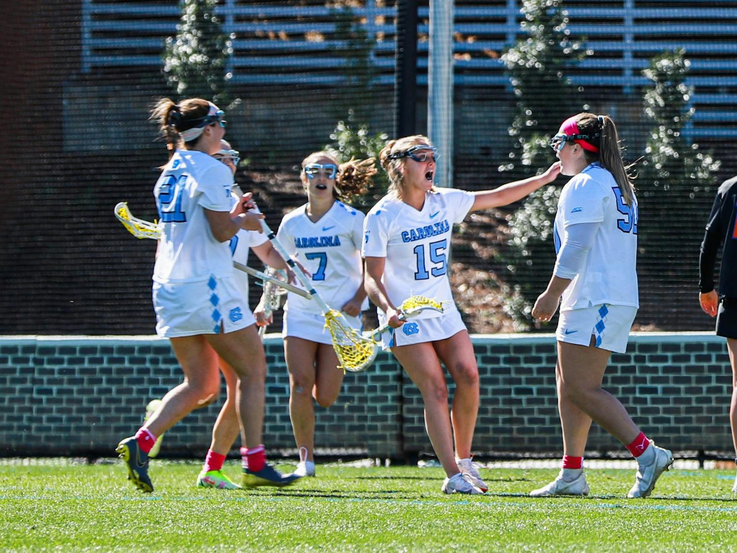 The UNC women’s lacrosse team celebrates after scoring a goal during the game against UF on Saturday, Feb. 18, 2023, at Dorrance Field. UNC beat UF 12-5.