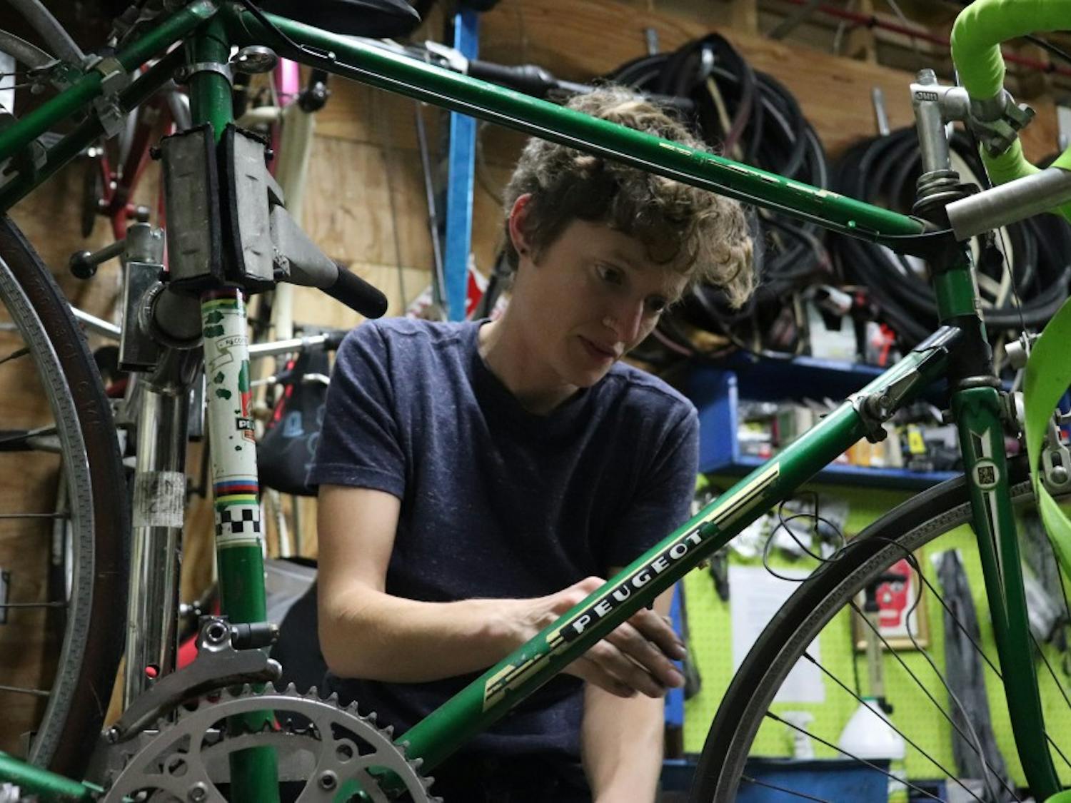 Christina Graves repairs a bike on Bike Wrenching Night at ReCYCLEry on Tuesday, Oct. 30. Bike Wrenching Night is an open shop held most Tuesdays aimed at women/trans/femme/non-binary individuals for bicycle repair and to improve mechanic skills.