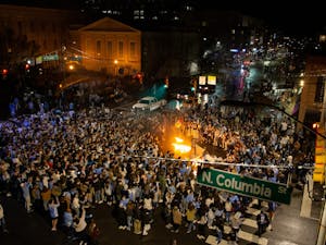 UNC fans rush Franklin Street  and light a mattress on fire after UNC's basketball team triumphs over Duke despite COVID-19 restrictions on Saturday, Feb. 6, 2021.