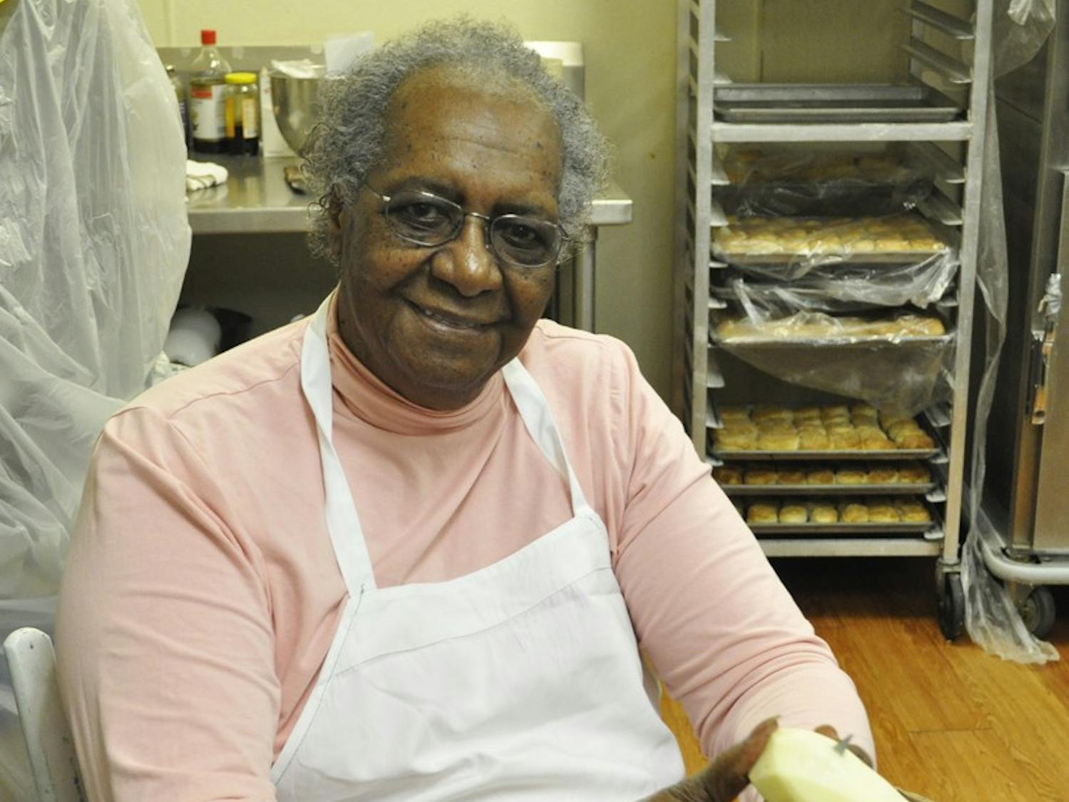 Mildred Council, known around Chapel Hill as ‘Mama Dip,’ peels potatoes in the kitchen of her restaurant that goes by the same name.  She will be judging a cooking contest.