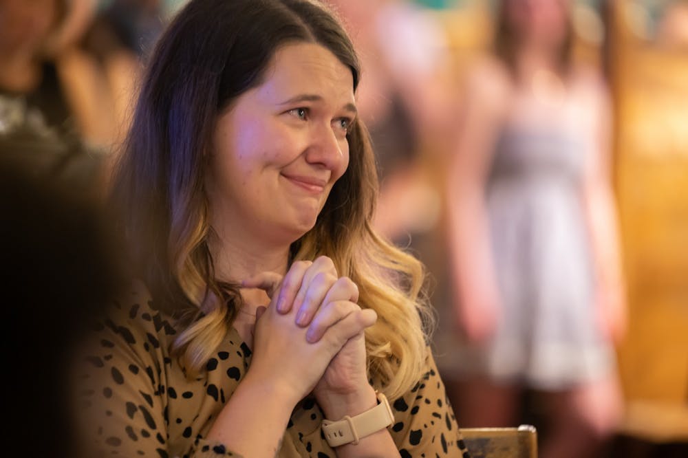 Paige Ladisic, the DTH's managing director of sales and strategy, listening to speeches at her farewell party Friday, April 22. Photo courtesy of Brandon Standley.