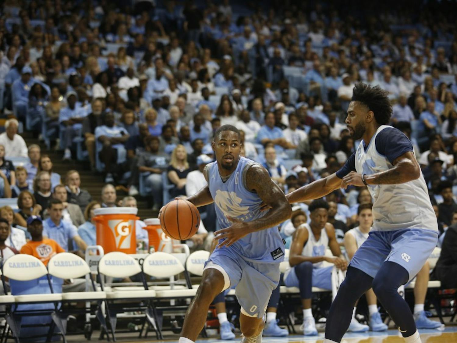 Guard Seventh Woods (0) dribbles around teammate Joel Berry II (2) in UNC's Late Night With Roy on Oct. 13.