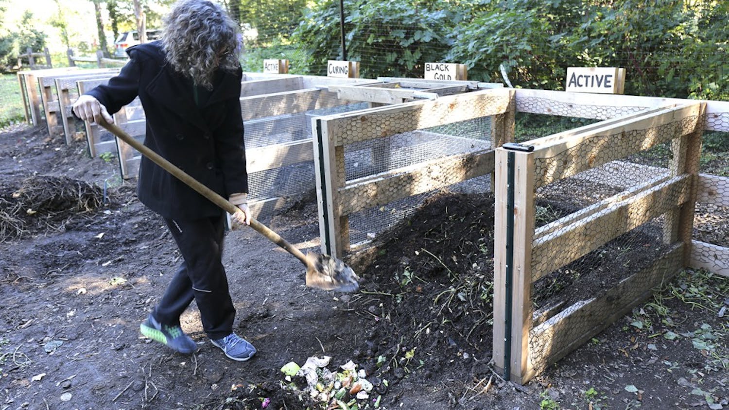 Claire Lorch, the garden manager and education coordinator for UNC’s community gardens, works on one of the newly constructed composts.