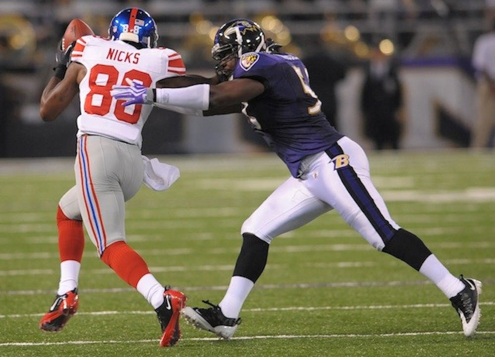 New York Giants wide receiver Hakeem Nicks, right, breaks one of several tackles, this attempt by Baltimore Ravens linebacker Jameel McClain, after making a reception during first-quarter action at M&T Stadium in Baltimore, Maryland, Saturday, August 28, 2010. (Doug Kapustin/MCT)
