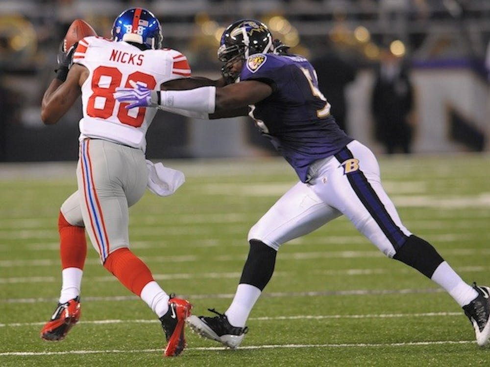  New York Giants wide receiver Hakeem Nicks, right, breaks one of several tackles, this attempt by Baltimore Ravens linebacker Jameel McClain, after making a reception during first-quarter action at M&T Stadium in Baltimore, Maryland, Saturday, August 28, 2010. (Doug Kapustin/MCT)