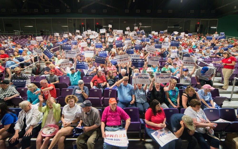 Donald Trump supporters hold up their signs. Republican presidential candidate Donald Trump spoke in the Greensboro Coliseum on Tuesday, June 14th.