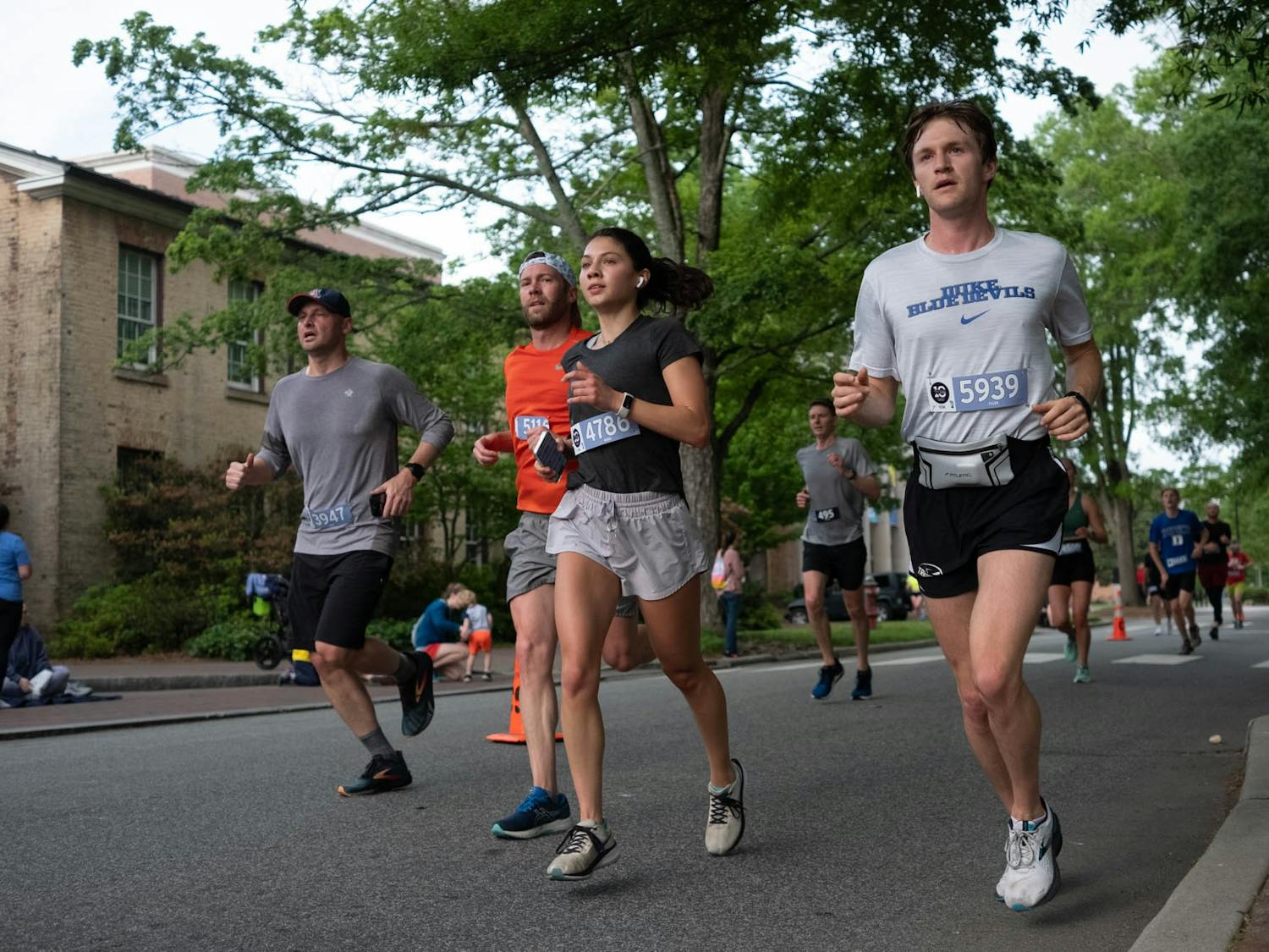 Racers sprint past Gerrard Hall during the Tar Heel Ten Miler on Saturday, April 22, 2023. The race took place on UNC's campus.