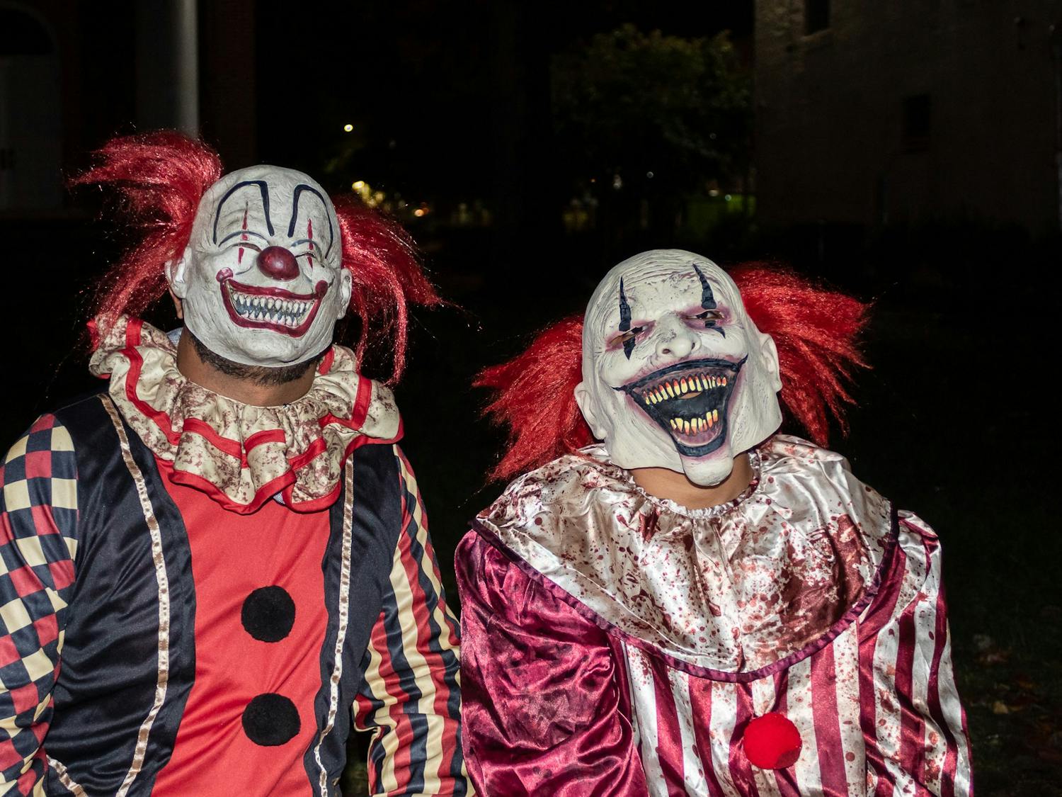 Two clowns smile for the camera during Halloween on Franklin Street on Monday, Oct. 31, 2022.