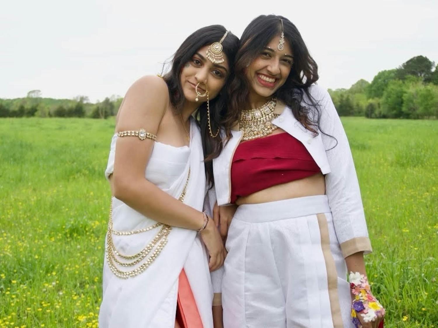 Pareen Bhagat(left), Hrishika Muthukrishnan(right) are dressed in clothing designed by Pareen Bhagat and accessorized in traditional Indian jewelry and colors. Photo courtesy of Izzy d'Alo.&nbsp;