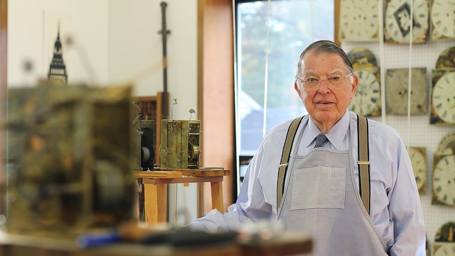 Dick Spangler stands in his workshop in Charlotte where he restores antique grandfather clocks.  					