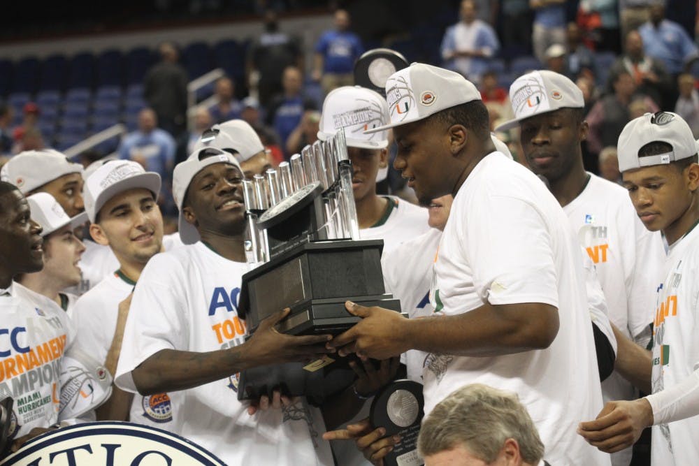 	Durand Scott and Reggie Johnson hoist the ACC Championship trophy.