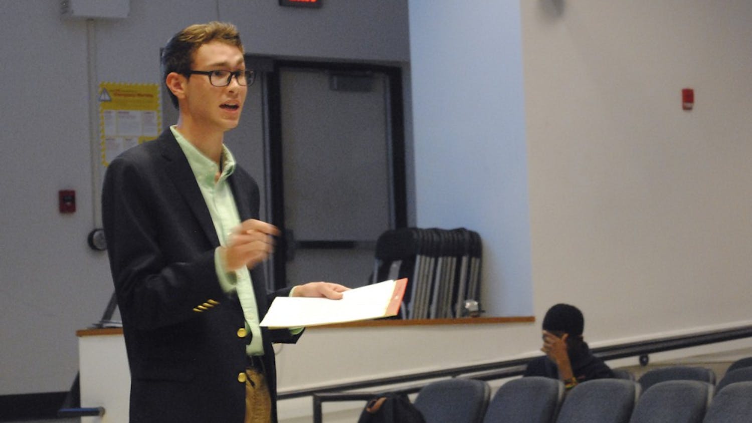 Graham Lowder, member of the Young Democrats, participates in a debate against the College Republicans on Wednesday. The teams discussed issues including climate change, immigration, and higher education. 