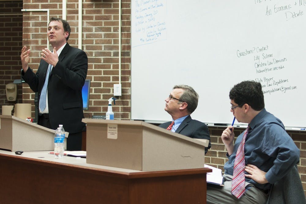 T. William Lester (left) and Adam Smith (right) debate the moral and economic impacts of possibly raising the federally mandated minimum wage at Van Hecke-Wettach Hall on Tuesday.