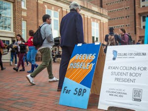 UNC faculty and students walk past ad campaigns in the Pit ahead of the Student Body President election on Feb. 10, 2020. Voting for the Student Body President Election begins on Feb. 11 at heellife.unc.edu.
