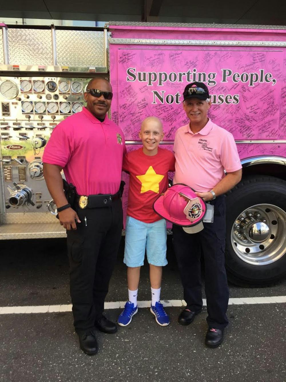 <p>Community liaison for crime prevention Lieutenant B. Green stands with Jackson Donahoe and&nbsp;Chapel Hill Fire Department Training Captain Byron Greeson.&nbsp;</p>