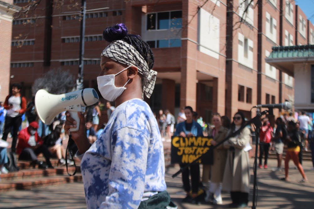 <p>A speaker from UNC's student-organized climate strike leads students from The Pit to South Building to demand changes in the UNC Climate Action Plan on Friday, March 25, 2022.</p>