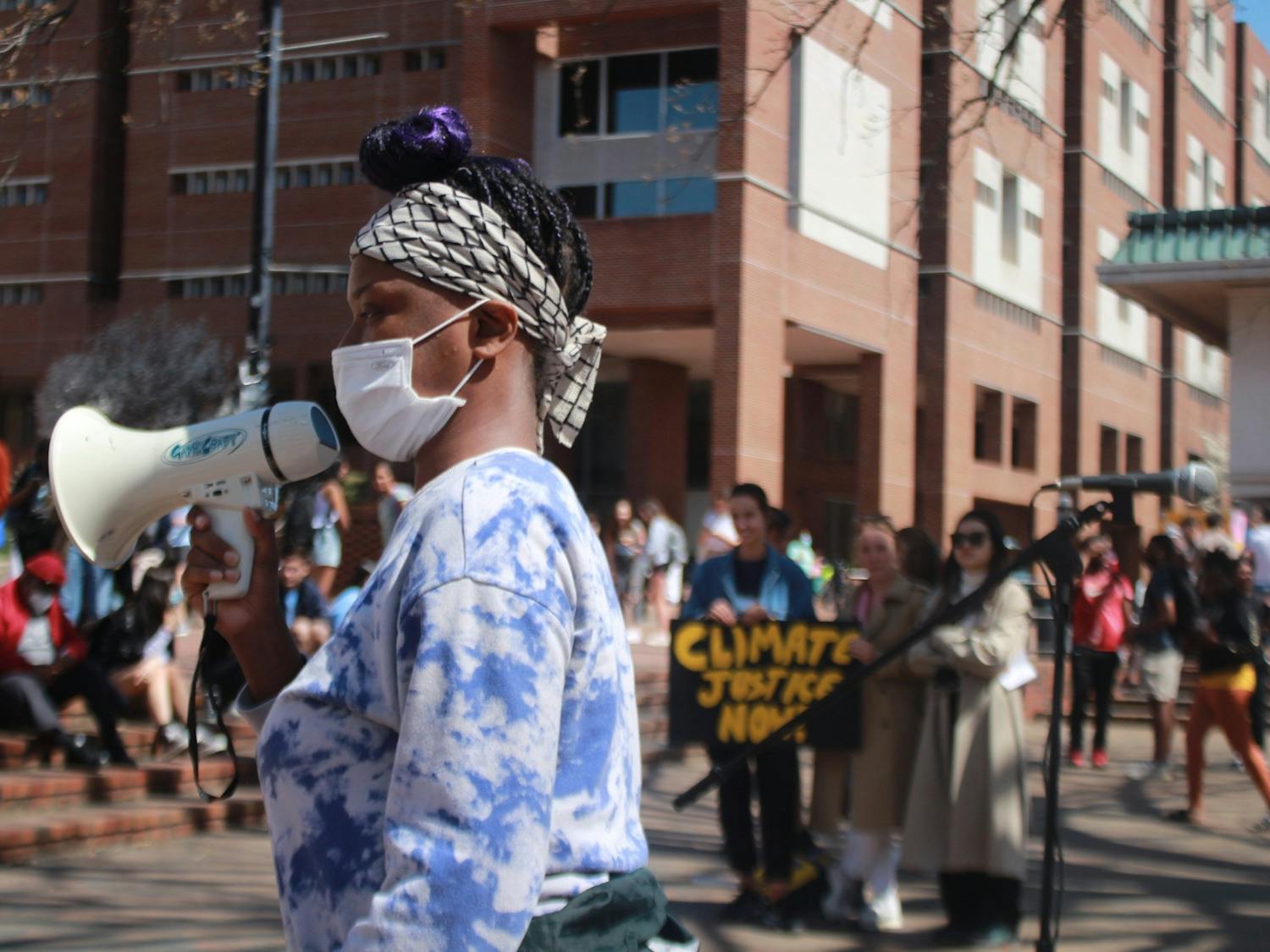 A speaker from UNC's student-organized climate strike leads students from The Pit to South Building to demand changes in the UNC Climate Action Plan on Friday, March 25, 2022.