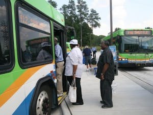 Residents board a Triangle Transit Authority bus going to downtown Durham. All GoTransit buses will be free to ride Thursday.&nbsp;