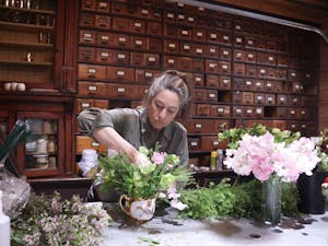 Morgan Howell Moylan, owner of West Queen Floral Studios in Hillsborough, NC, works on a centerpiece on Friday, April 8, 2022, for an upcoming wedding.