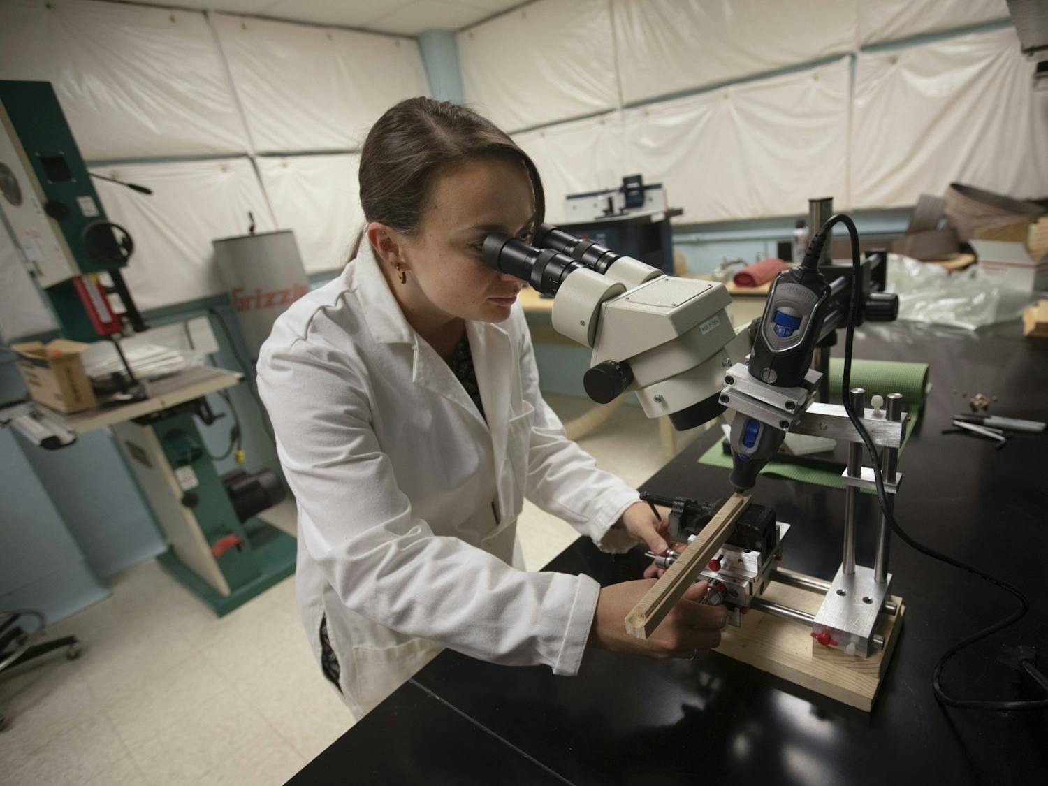 Karly Schmidt-Simard, a PhD candidate in Erika Wise's dendrochronology lab, drills a tree core sample to prepare it for chemical analysis on August 29, 2019. Photo courtesy of Megan May/UNC Research