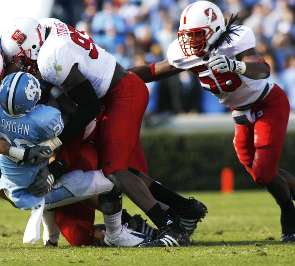 Senior linebacker Nate Irving converges on UNC running back Shaun Draughn in 2008. Irving sat out the 2009 season after suffering major injuries in a one-car accident. He now leads the team in tackles and sacks.